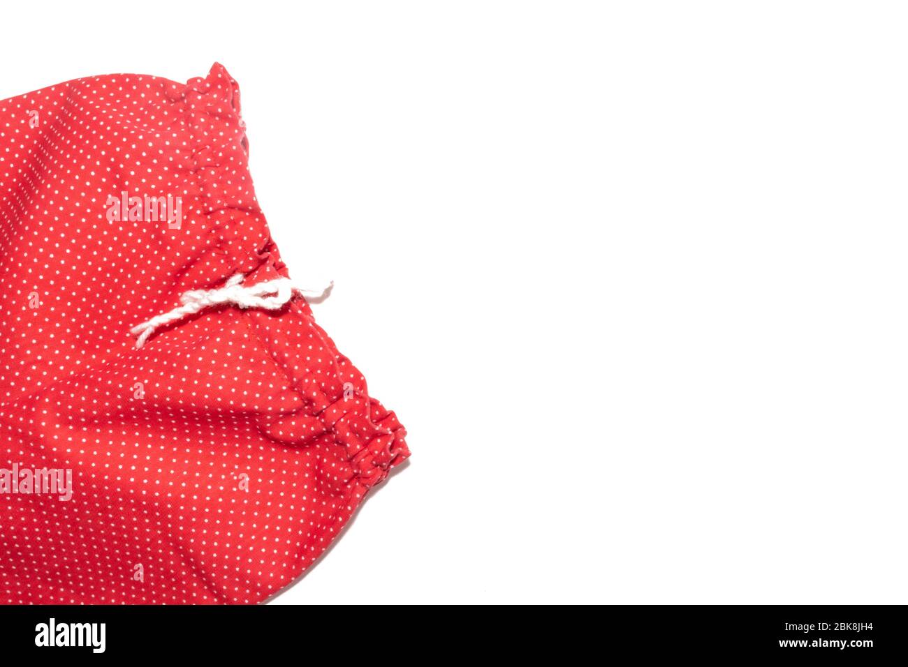 Kid's red with white polka dot pattern pants isolated on white background. Stock Photo