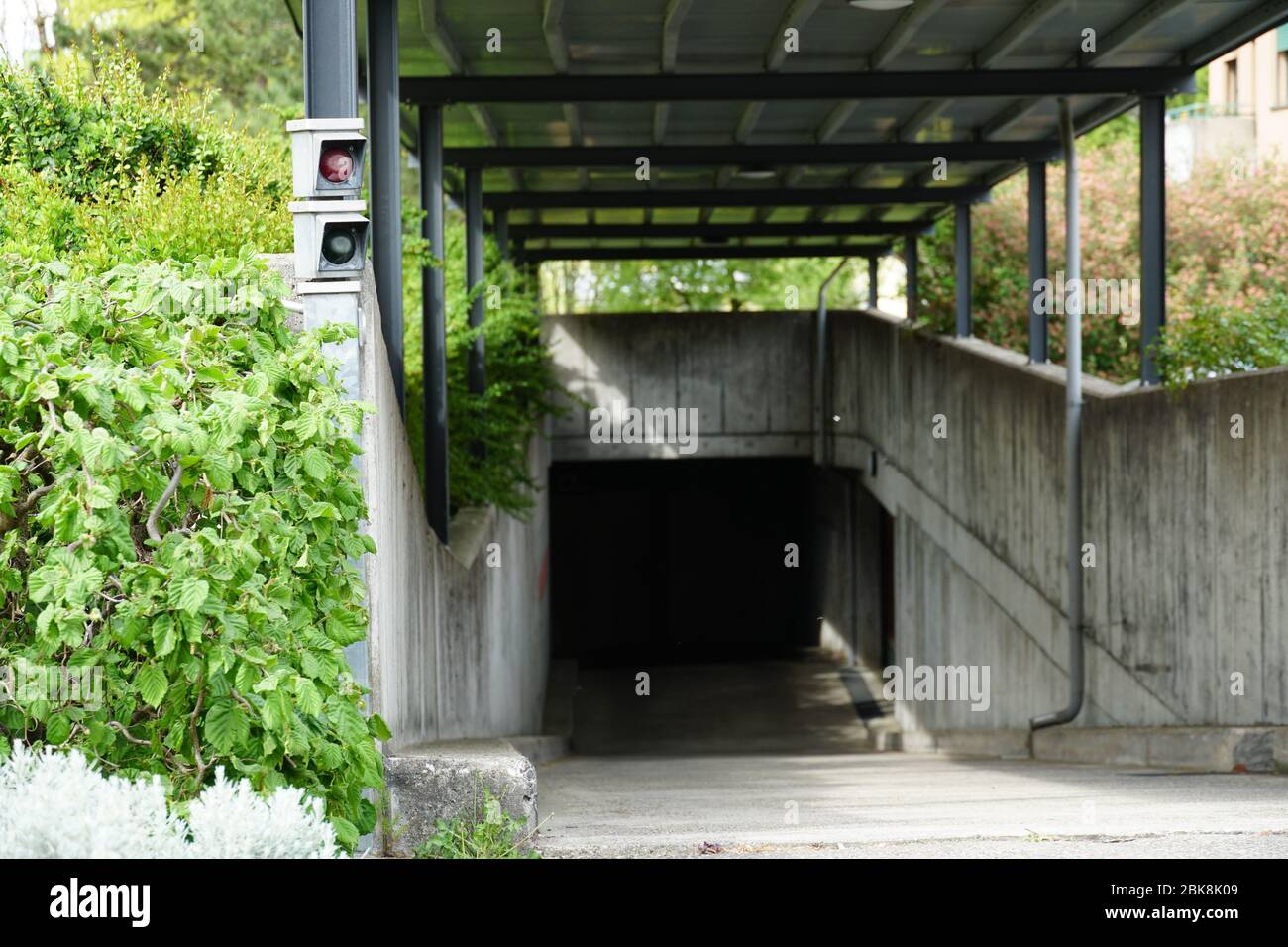 One lane entrance and exit of an underground concrete garage or parking ...