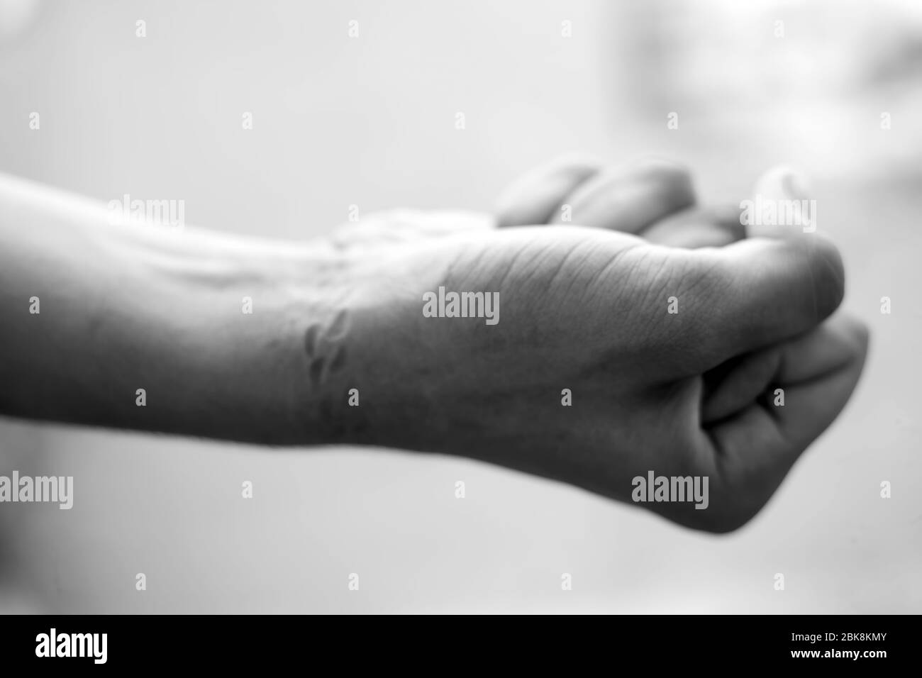 Shot of male hand with the impact of chain tied on his wrist. Shot of
