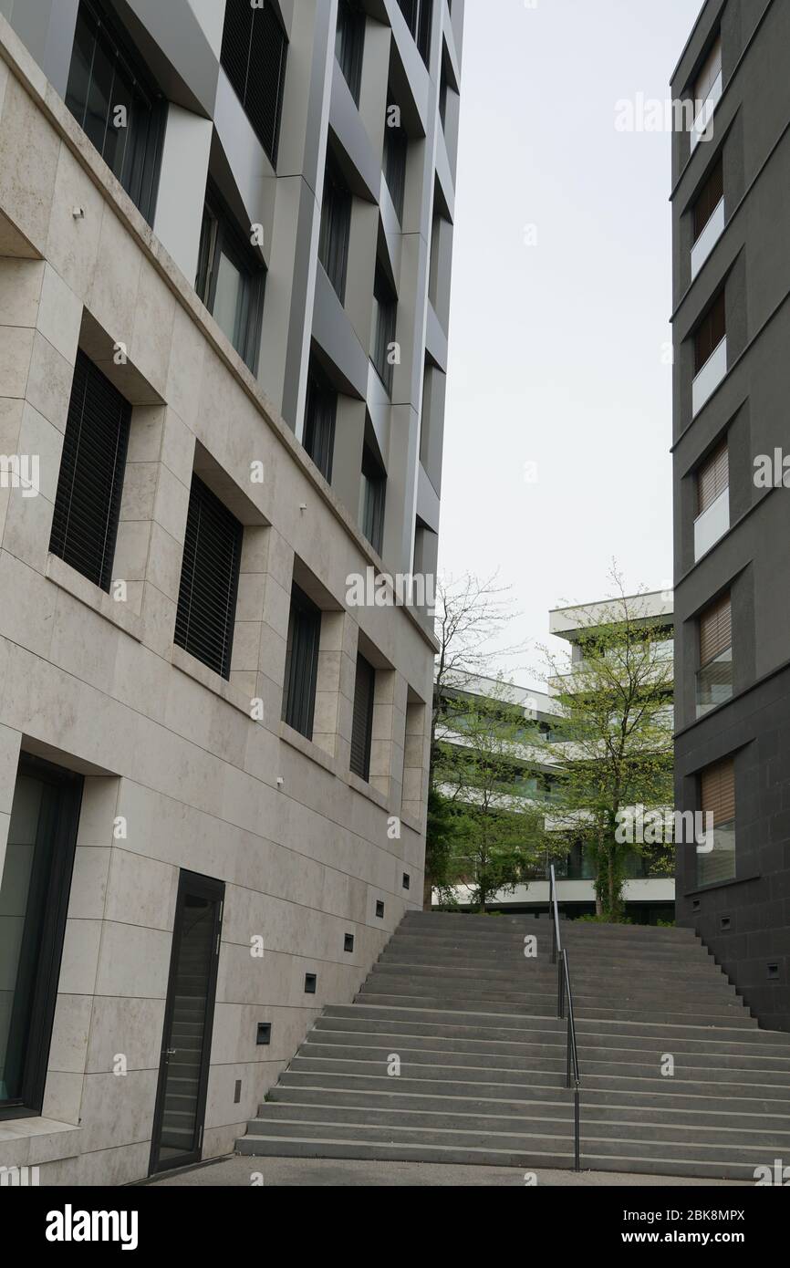 Corporate, modern office buildings on both sides of a street advancing to each other in the perspective. Stock Photo
