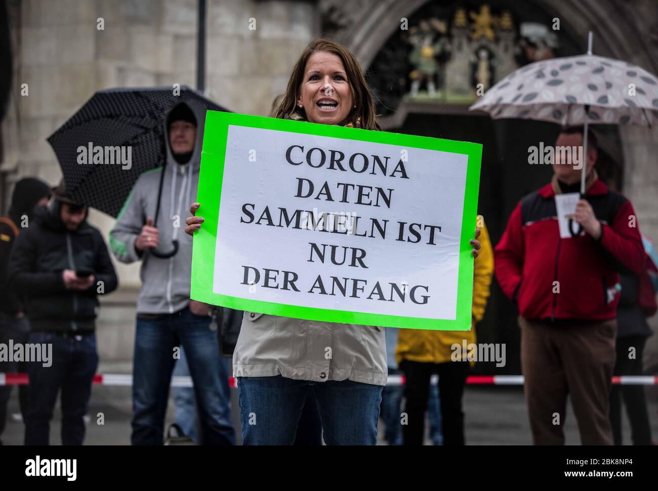Munich, Bavaria, Germany. 2nd May, 2020. A demonstrator at a conspiracy theorist demo in Munich, Germany holds a sign opposing the collecting of data in contact tracing for coronavirus cases.On the heels of a violent attack against ZDF journalists in Berlin, the Munich Hygienedemos took place again, complete with conspiracy theorists, right-extremists, neonazis, Hooligans, AfD members, insults and aggression towards journalists and police, and violations of the infection protection laws. Organized in Telegram chats by conspiratorial 'Querfront'' (cross-front) groups, the organizers planned s Stock Photo