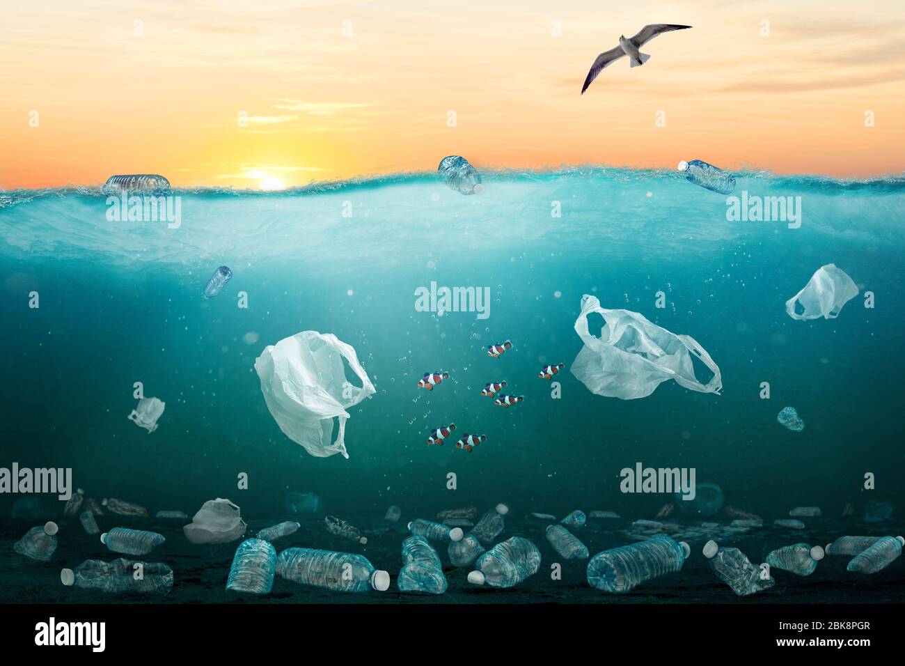 Marine pollution concept showing sunrise over ocean full of plastic trash. At least 8 million tons of plastic end up in oceans every year and make maj Stock Photo