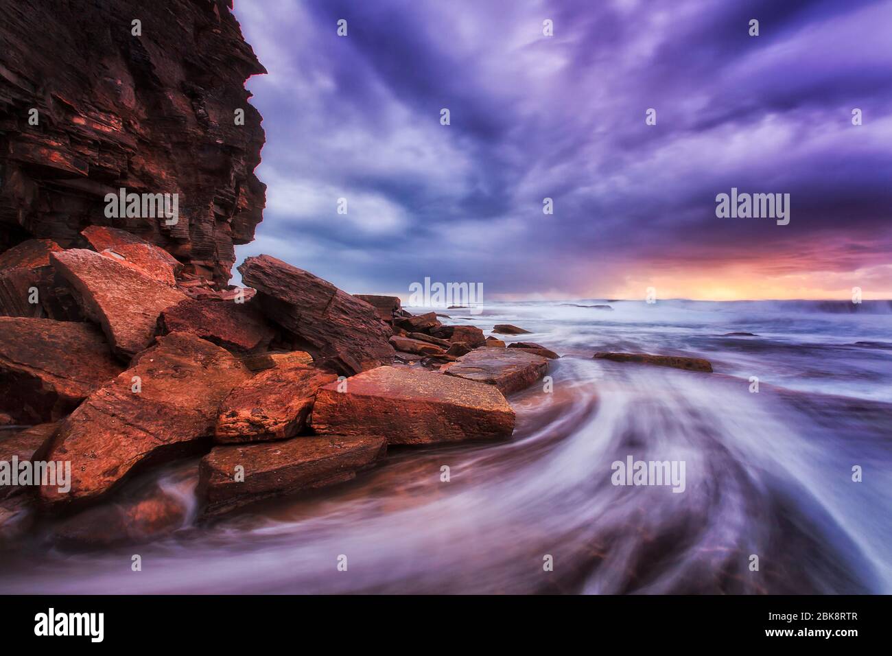 Waves and surf of high tide at sunrise on Sydney Nonrthern beaches in stormy weather Stock Photo