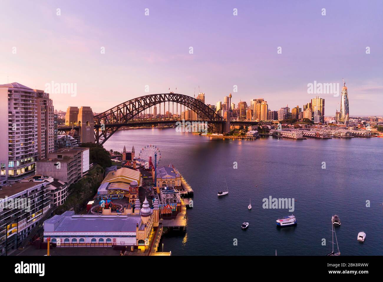 Aerial view over entertainment park and walkway on shores of Lavender bay of Sydney Harbour at sunrise. Stock Photo