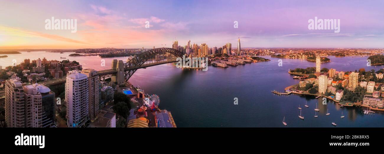 Lavender bay on Sydney Harbour in front of city CBD and major landmarks in wide aerial panorama at sunrise. Stock Photo