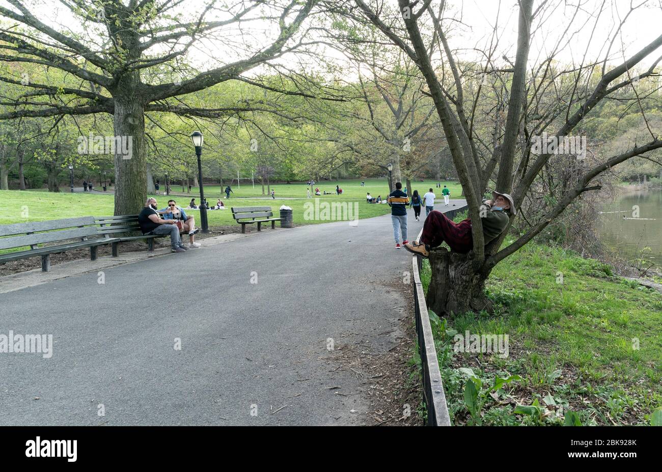 New York, NY - May 2, 2020: People enjoy very warm day amid COVID-19 pandemic in Inwood Hill Park Stock Photo