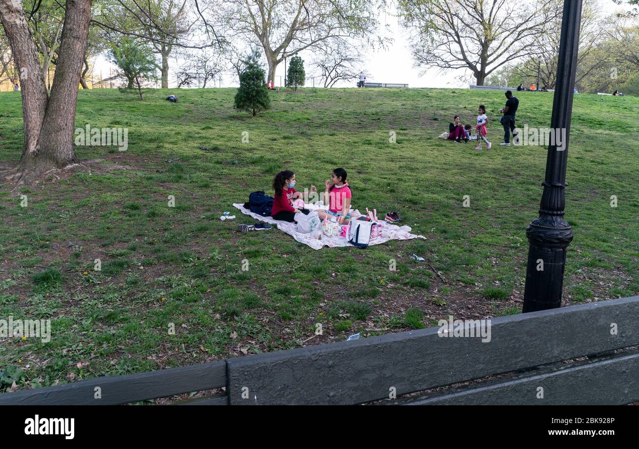 New York, NY - May 2, 2020: People enjoy very warm day amid COVID-19 pandemic in Inwood Hill Park Stock Photo