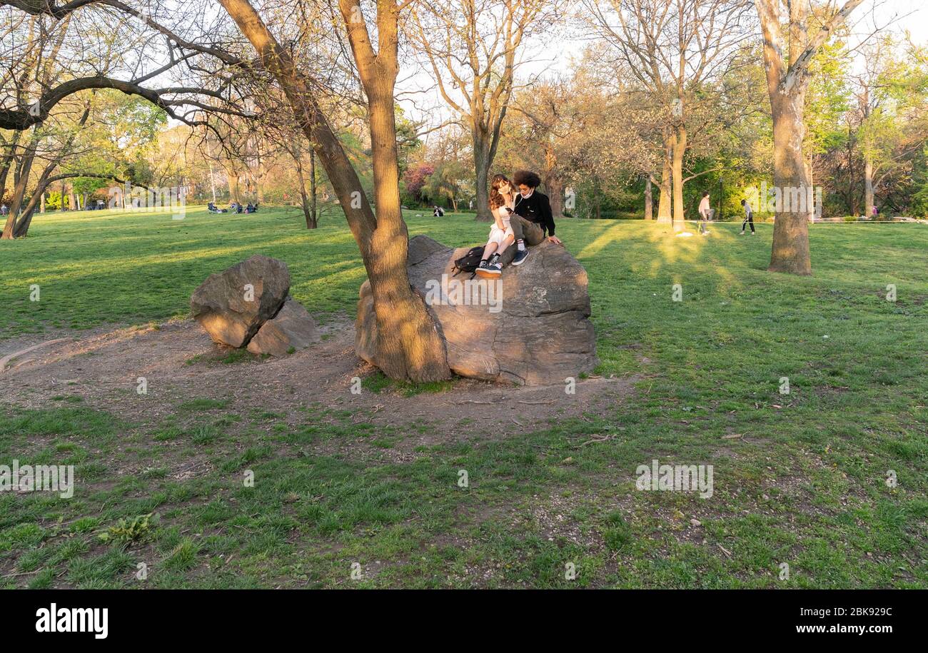 New York, NY - May 2, 2020: People enjoy very warm day amid COVID-19 pandemic in Inwood Hill Park Stock Photo