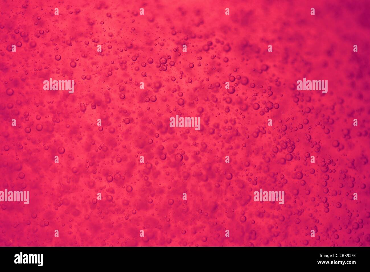 Pink, red, purple, vivid bright liquid with bubbles. Stock Photo
