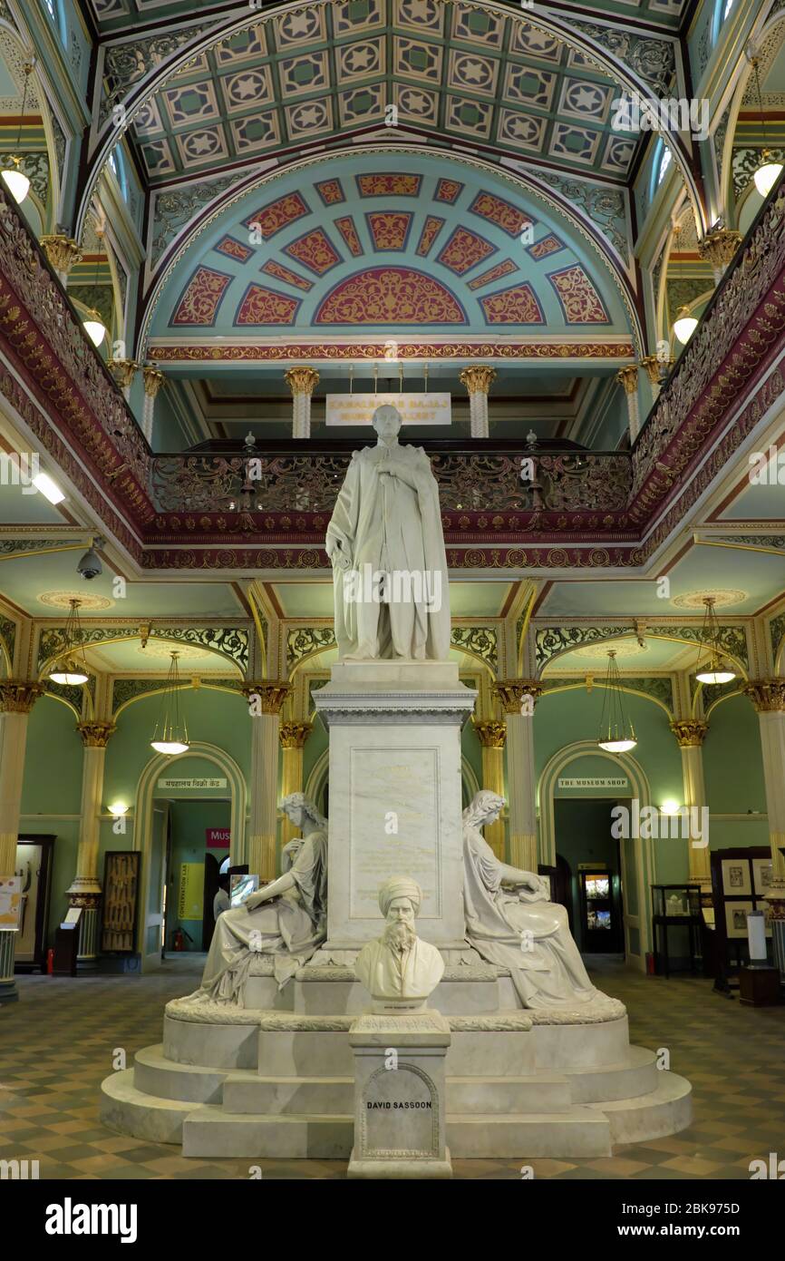 Inside view of Dr. Bhau Daji Lad Museum in Mumbai, India, with a statue of Prince Albert in the center and in front of it a bust of David Sassoon Stock Photo