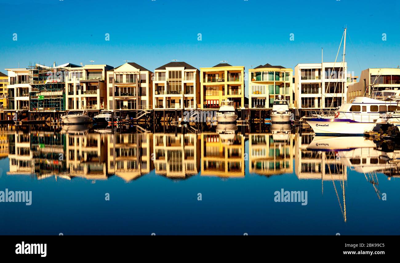 Apartment building reflected in water at Glenelg Marina near Adelaide in South Australia Stock Photo