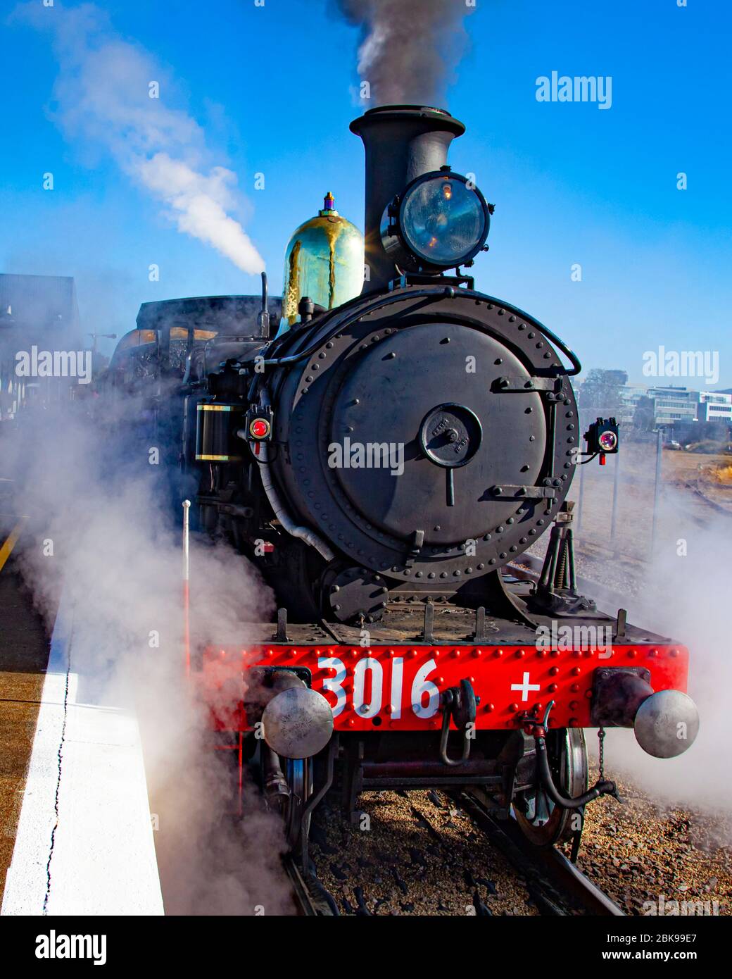 Restored engine making steam ready to leave Canberra Railway Station for trip to Bungendore in New South Wales Stock Photo