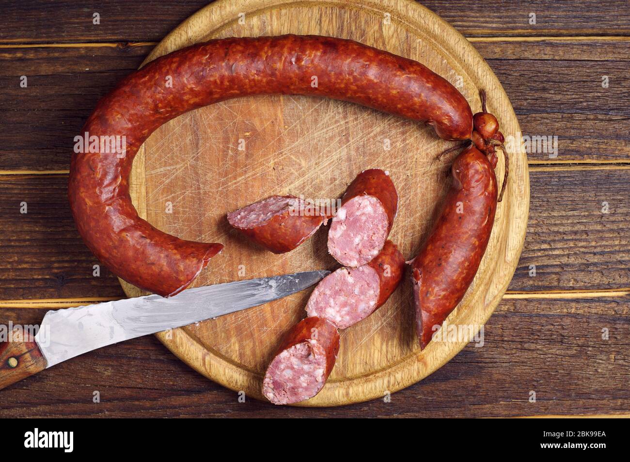 Fatty smoked sausage on a kitchen board, top view Stock Photo Alamy