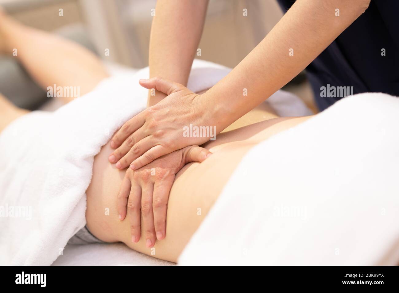 Young woman receiving a back massage in a physiotherapy center Stock Photo