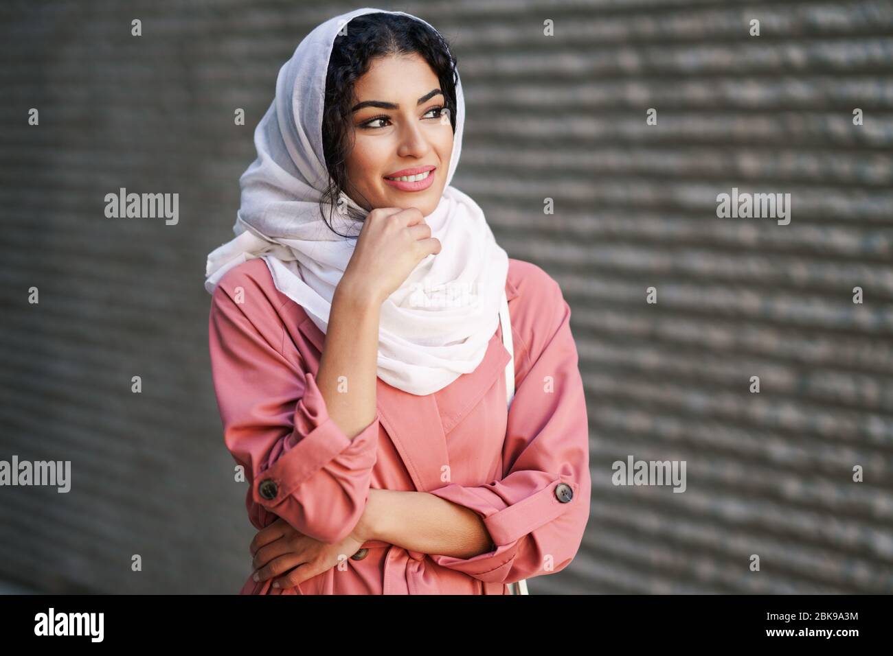 Young Arab woman wearing hijab headscarf walking in the city center ...