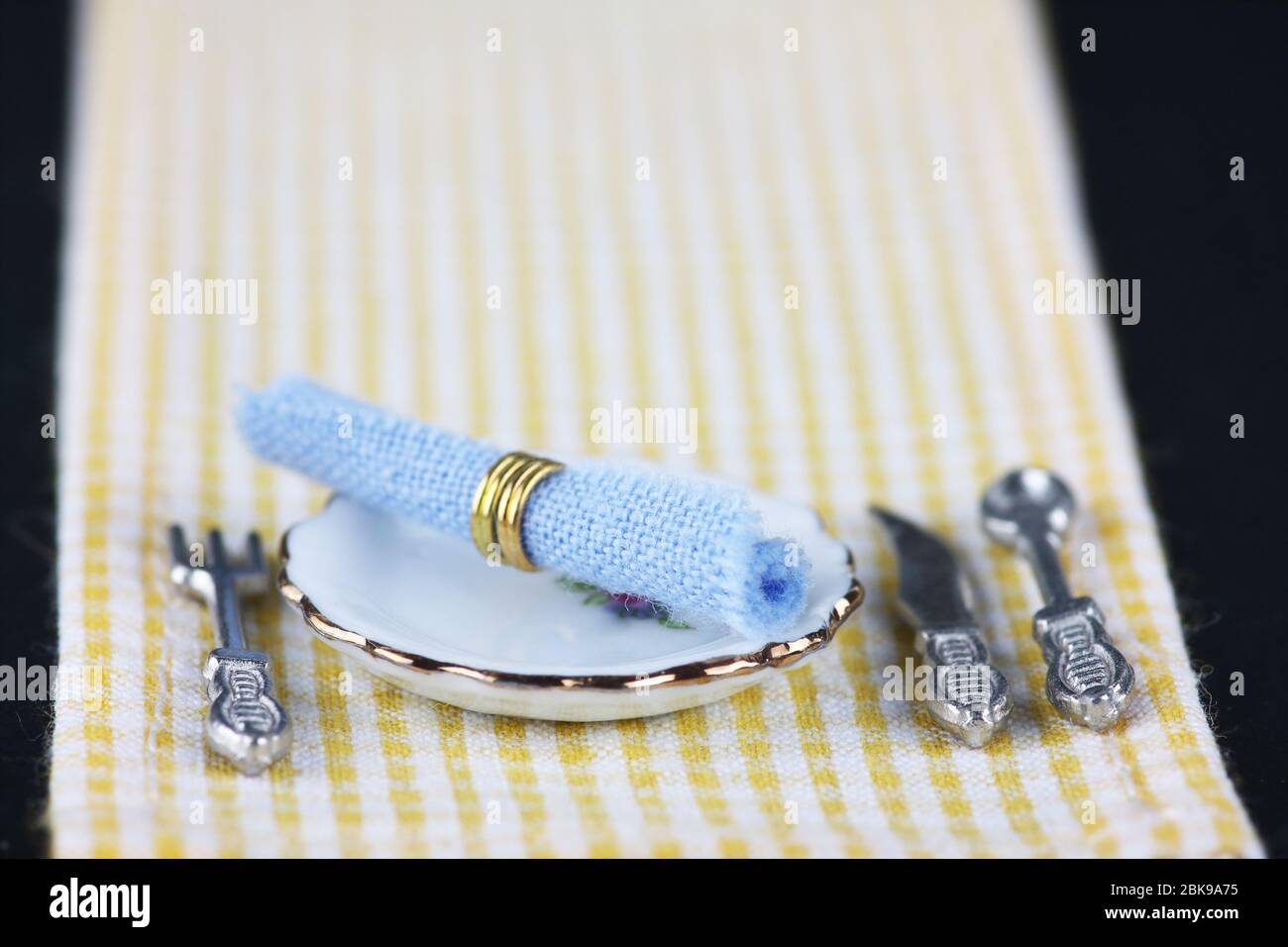 table setting on white and yellow checkered tablecloth Stock Photo
