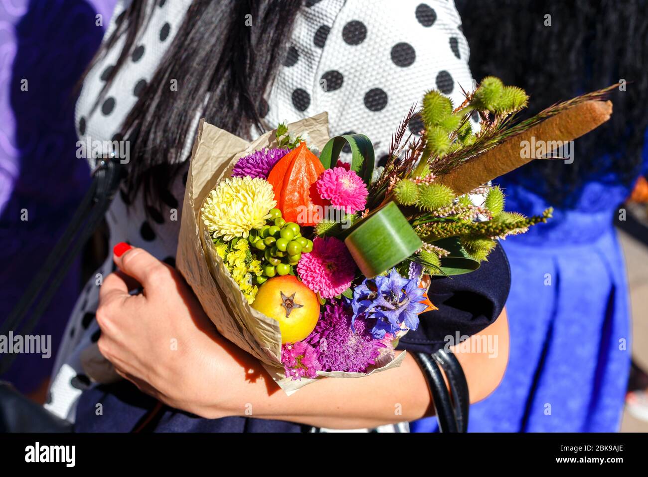 woman holding an unusual original bouquet Stock Photo