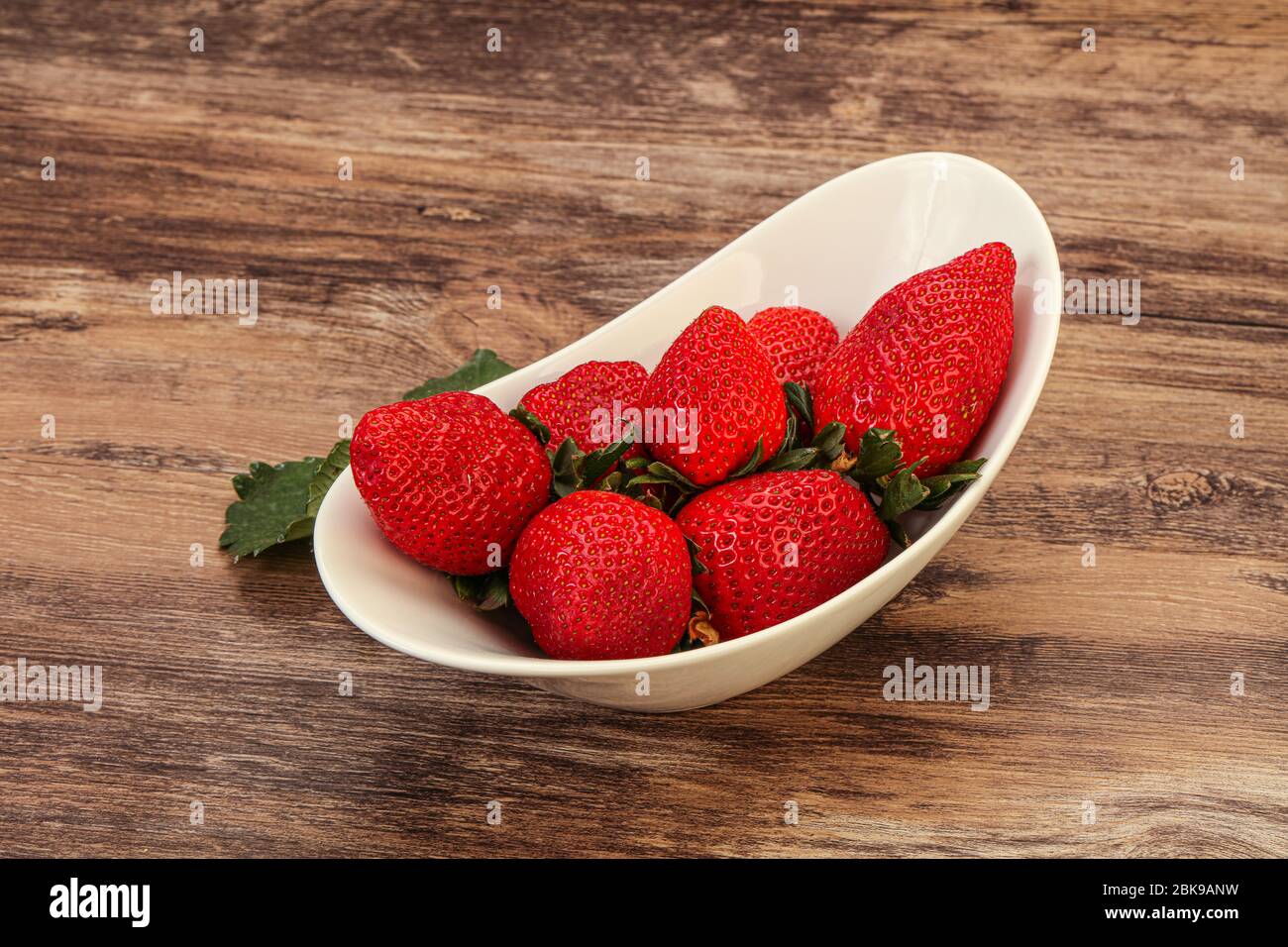 Ripe sweet strawberry in the bowl with leaf Stock Photo - Alamy