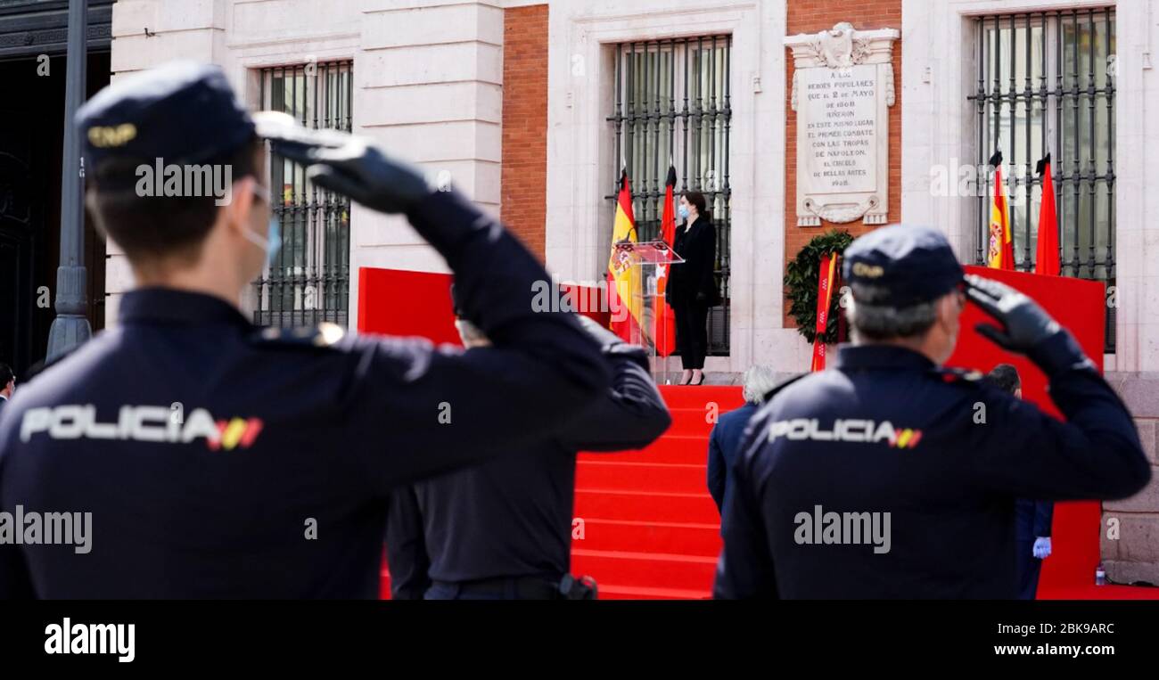 (200503) -- MADRID, May 3, 2020 (Xinhua) -- Isabel Diaz Ayuso (C), the President of the Madrid Region, and members of the police observe a moment of silence for COVID-19 victims at the Puerta del Sol square in Madrid, Spain, May 2, 2020. (Madrid Region Government/Handout via Xinhua) Stock Photo