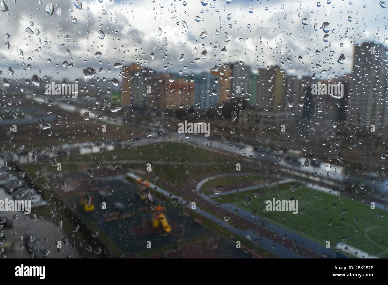 Waterdrops on a glass surface windows with cityscape background Stock Photo