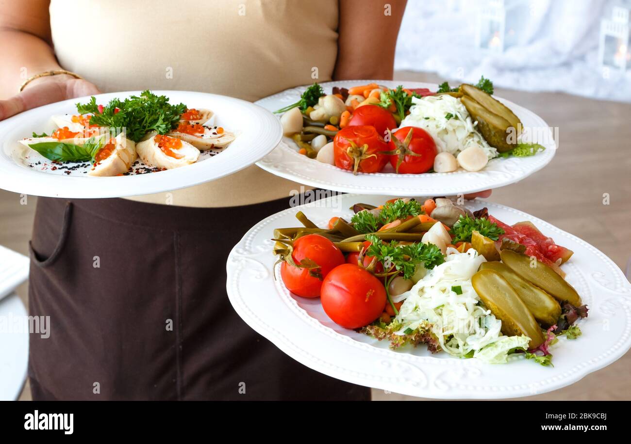 Restaurant waiter carrying plates hires stock photography and images
