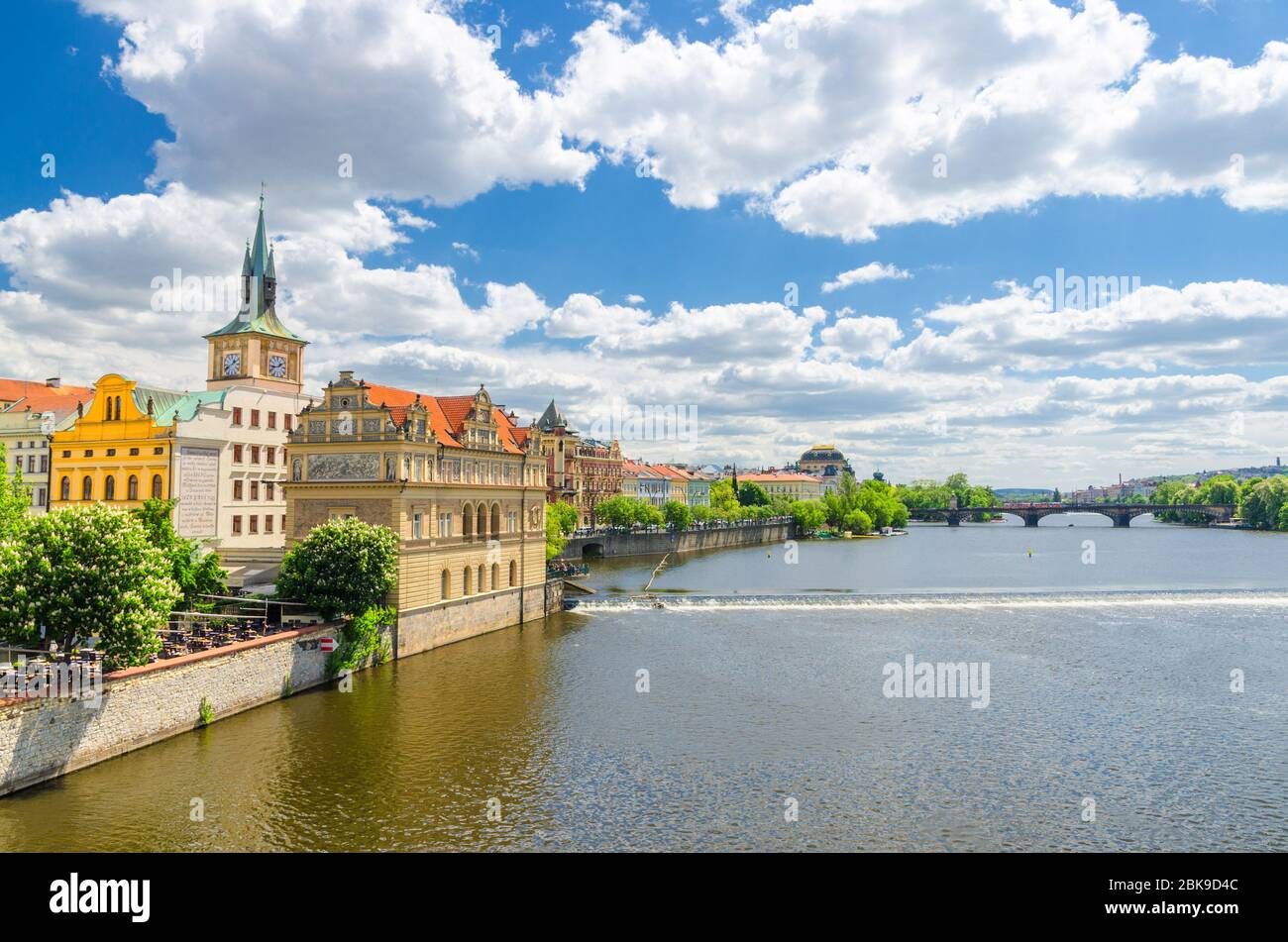Prague, Czech Republic, May 13, 2019: Bedrich Smetana Museum on the bank of Vltava river in old town historical city center, view from Charles Bridge Karluv Most, blue sky white clouds, Bohemia Stock Photo