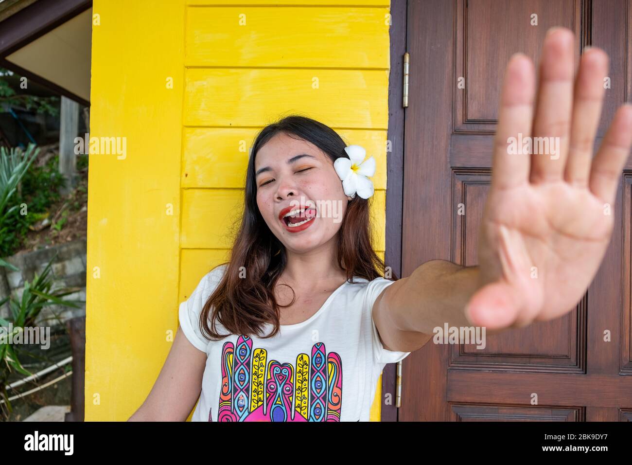 Asian woman , show palms, hands, stop sign. Focus on the face. Cute thai girl making a funny face Stock Photo