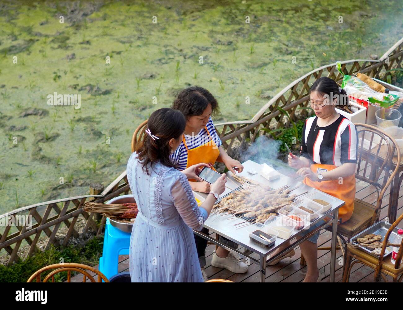 Chongqing, China's Chongqing Municipality. 2nd May, 2020. Tourists barbecue at backyard of a homestay hotel in Lieshen Village, southwest China's Chongqing Municipality, May 2, 2020. Located deep in mountains, Lieshen Village has made great efforts on developing rural tourism in recent years, as a way to boost local people's income. With the help of local authorities, villagers turn farmhouses into homestay hotels and make rural landscape as scenic spots attract tourists. Credit: Liu Chan/Xinhua/Alamy Live News Stock Photo