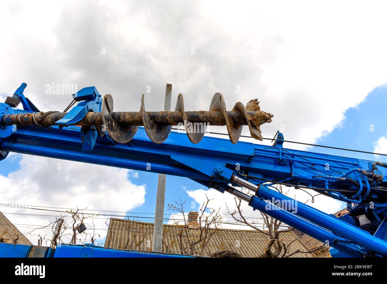 Tracer tractor with auger for soil drilling for piles installation