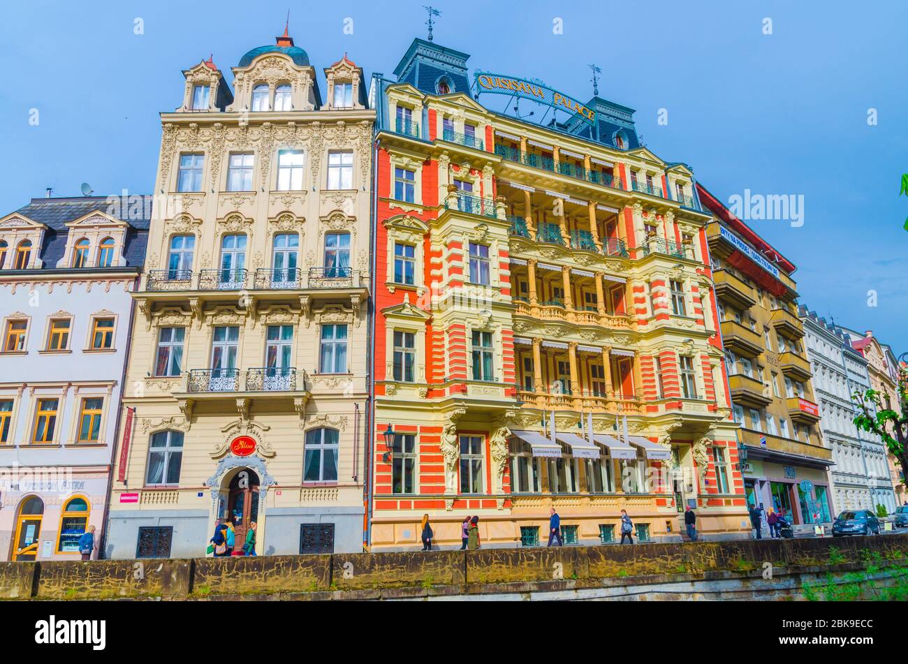 Karlovy Vary, Czech Republic, May 11, 2019: Quisisana Palace hotel building and Tepla river embankment in Carlsbad historical city centre, blue sky background, West Bohemia Stock Photo