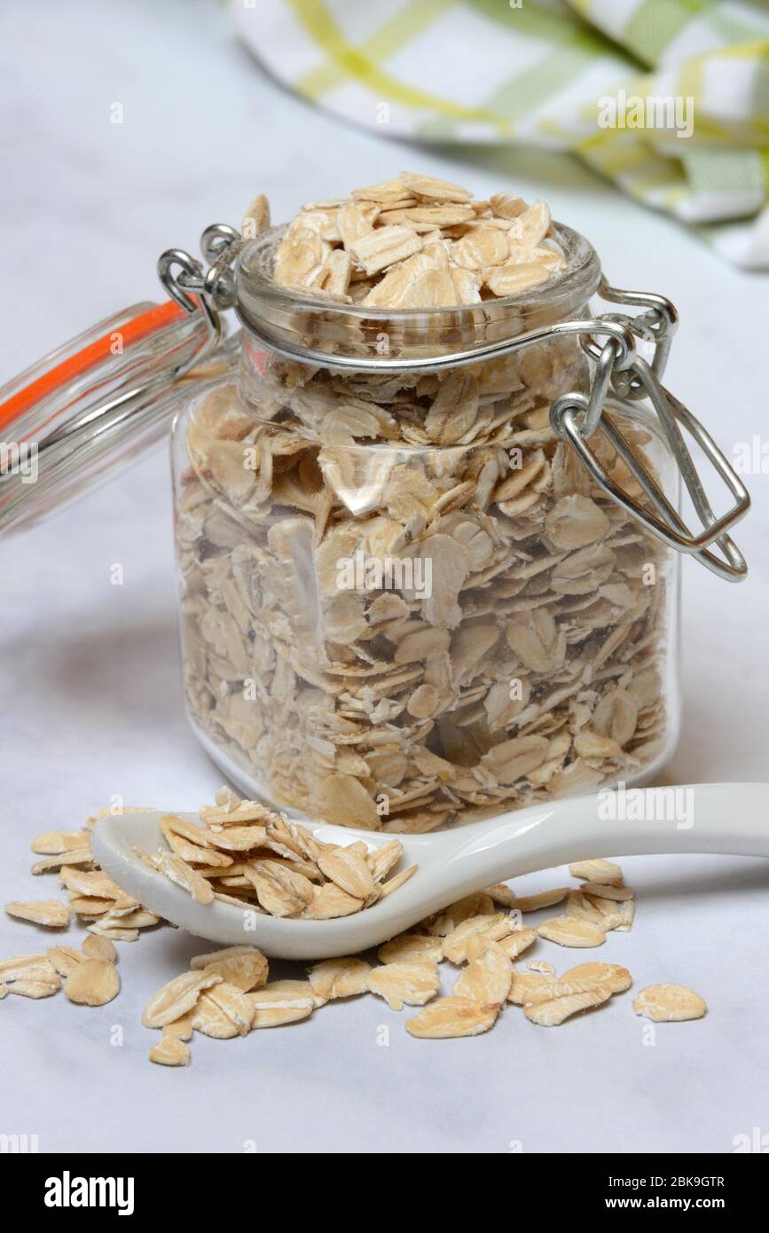 Oat flakes in preserving jar and spoon, Germany Stock Photo
