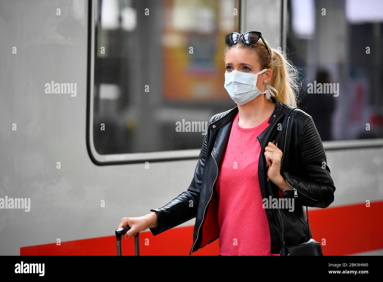 Woman with face mask, waiting for train, corona crisis, main station, Stuttgart, Baden-Wuerttemberg, Germany Stock Photo