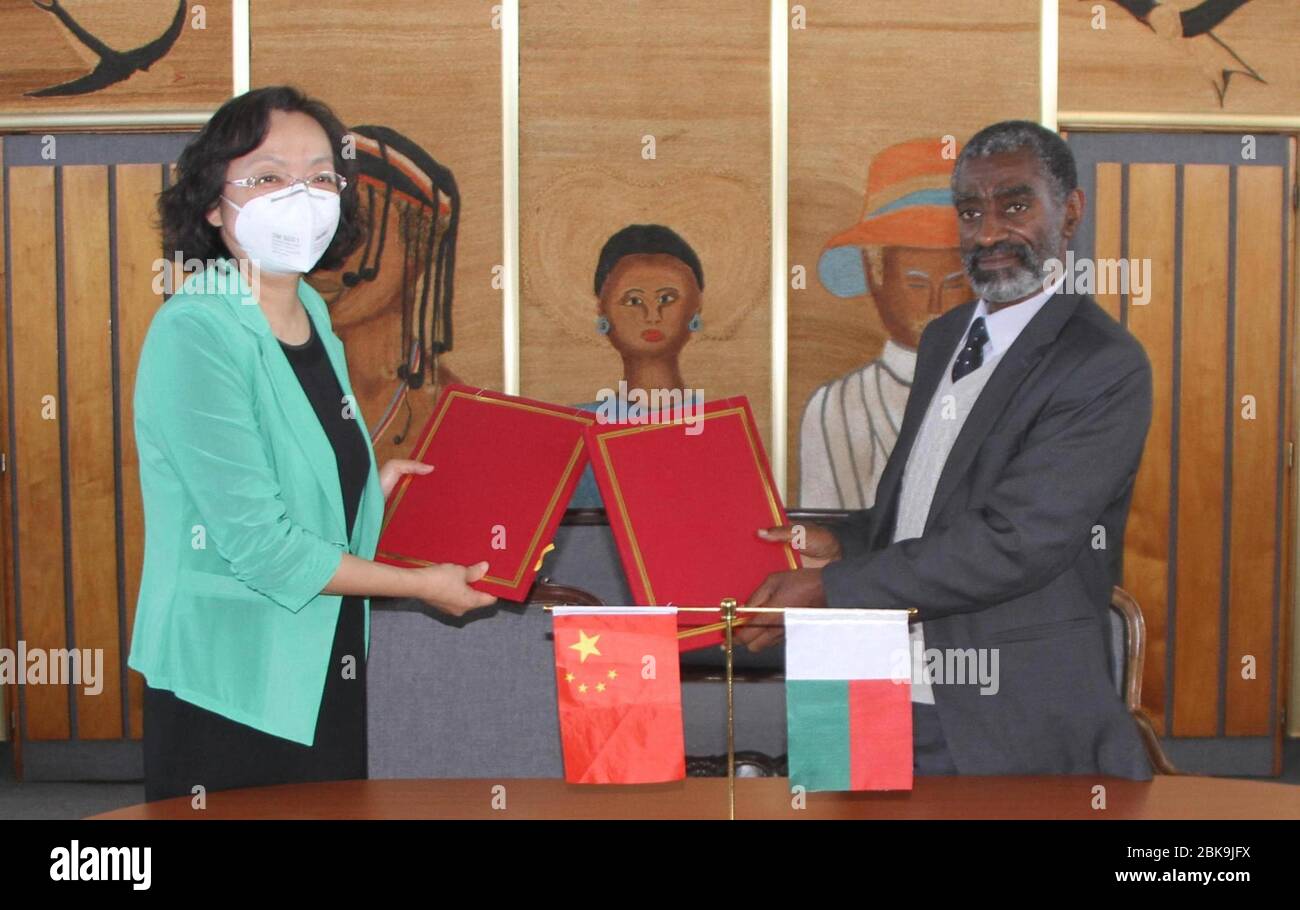 Tananarive, Madagascar. 2nd May, 2020. Chinese Ambassador to Madagascar Yang Xiaorong (L) and Madagascar's health minister Ahmad Ahmad exchange signed documents at a handover ceremony of medical supplies donated by China at Ivato International Airport in Tananarive, Madagascar, May 2, 2020. The first batch of medical supplies donated by China, including medical protective suits, infrared thermometers, face masks and safety goggles, were handed over to Madagascar after arriving here on Saturday. Credit: Sitraka/Xinhua/Alamy Live News Stock Photo