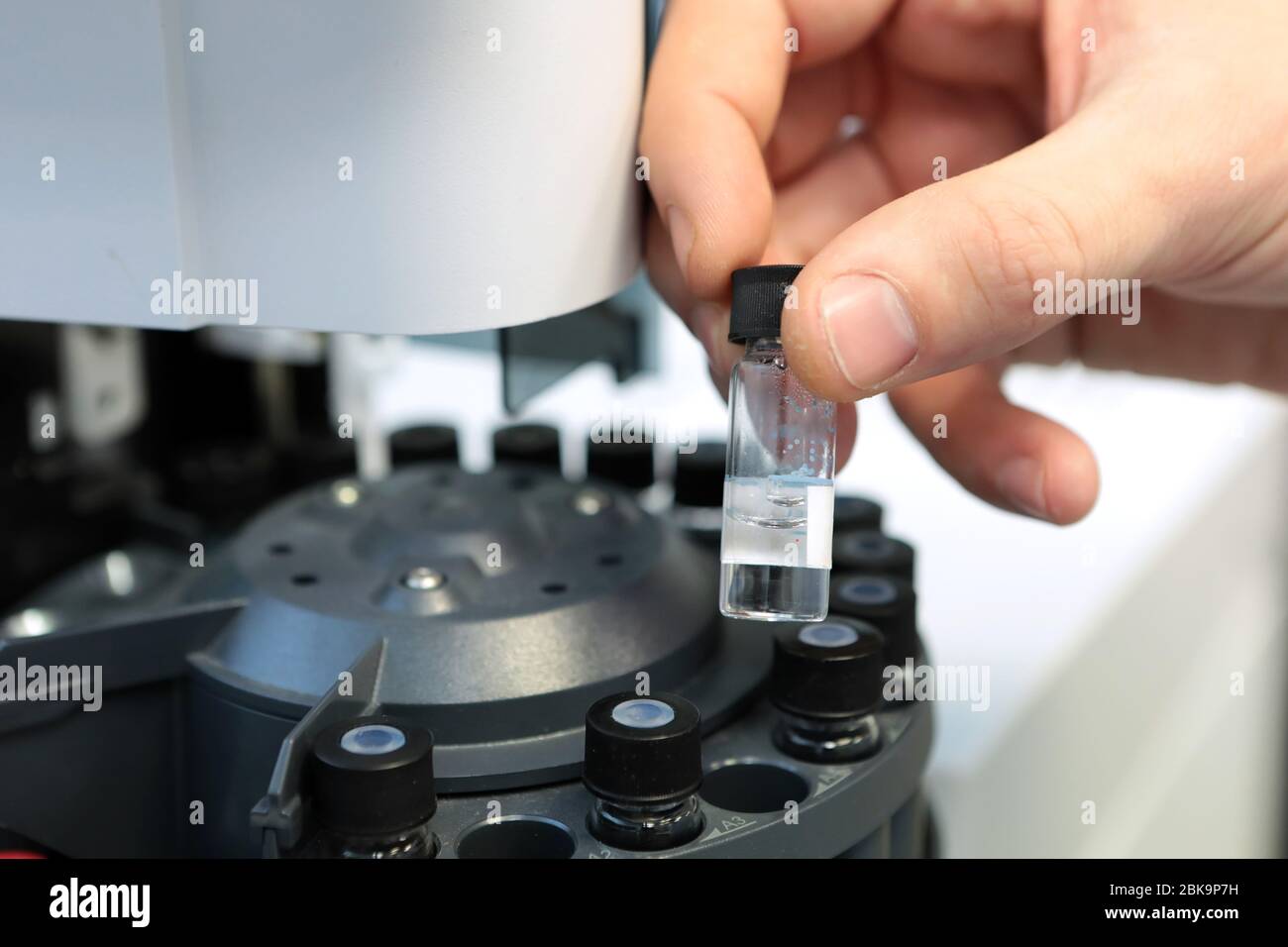 Scientist holds a chemical sample bottle. Doctor hand in medical glove ...