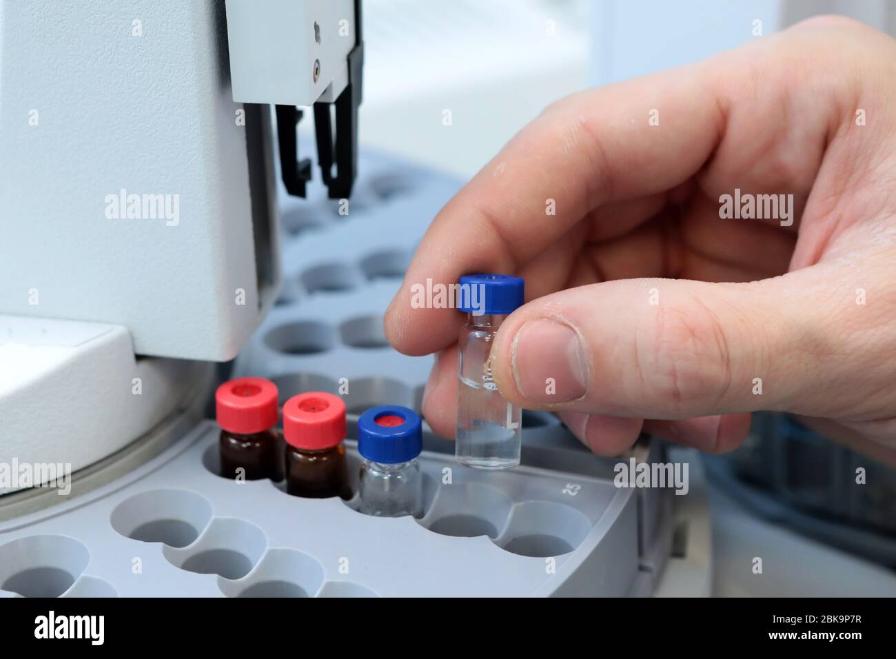 Scientist holds a chemical sample bottle. Doctor hand in medical glove ...