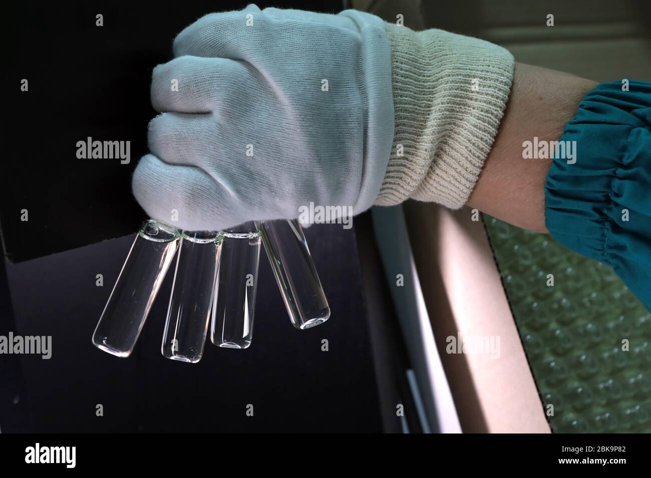 Scientist holds a chemical sample bottle. Doctor hand in medical glove ...
