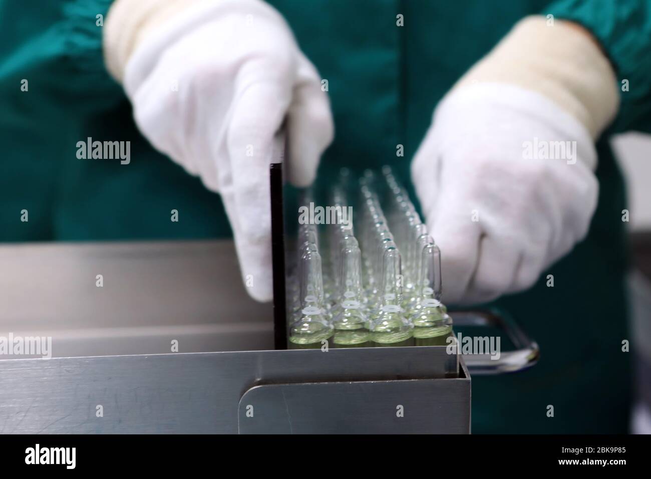 Scientist holds a chemical sample bottle. Doctor hand in medical glove ...