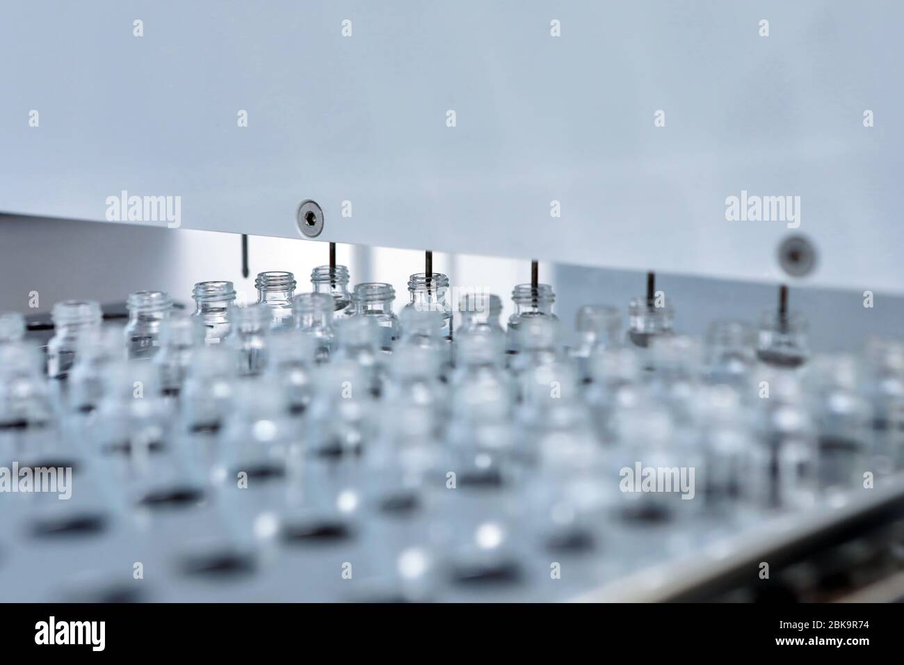 Sterile bottles and ampoules on the dispensing line. Sealed ampoules