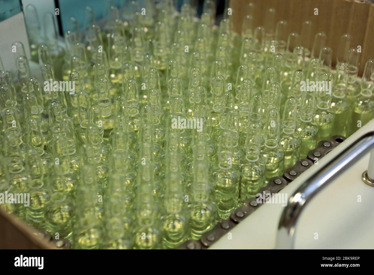 Sterile bottles and ampoules on the dispensing line. Sealed ampoules
