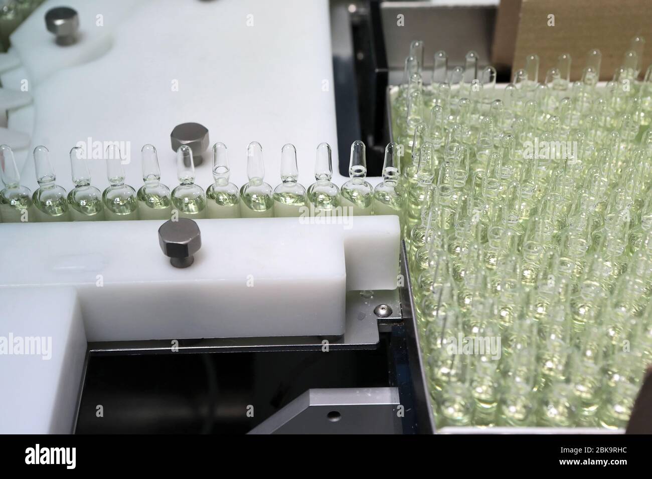 Sterile bottles and ampoules on the dispensing line. Sealed ampoules