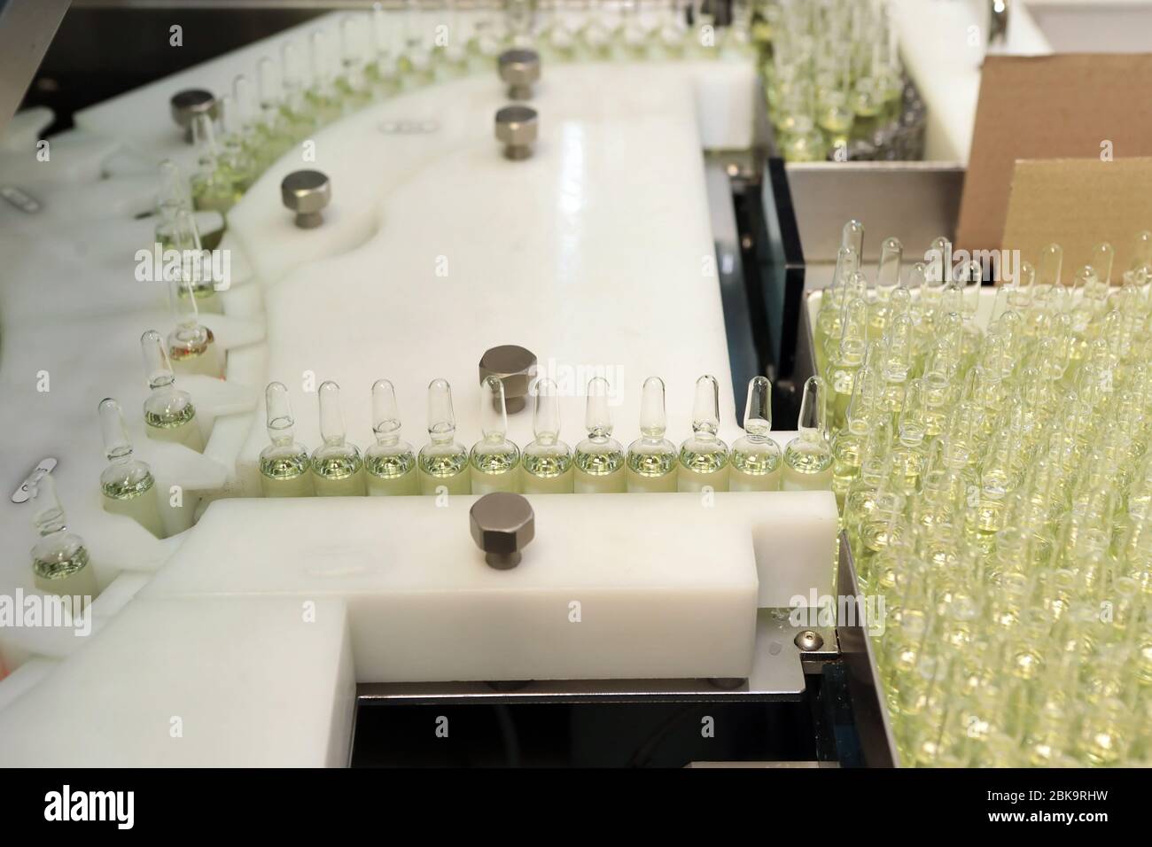 Sterile bottles and ampoules on the dispensing line. Sealed ampoules