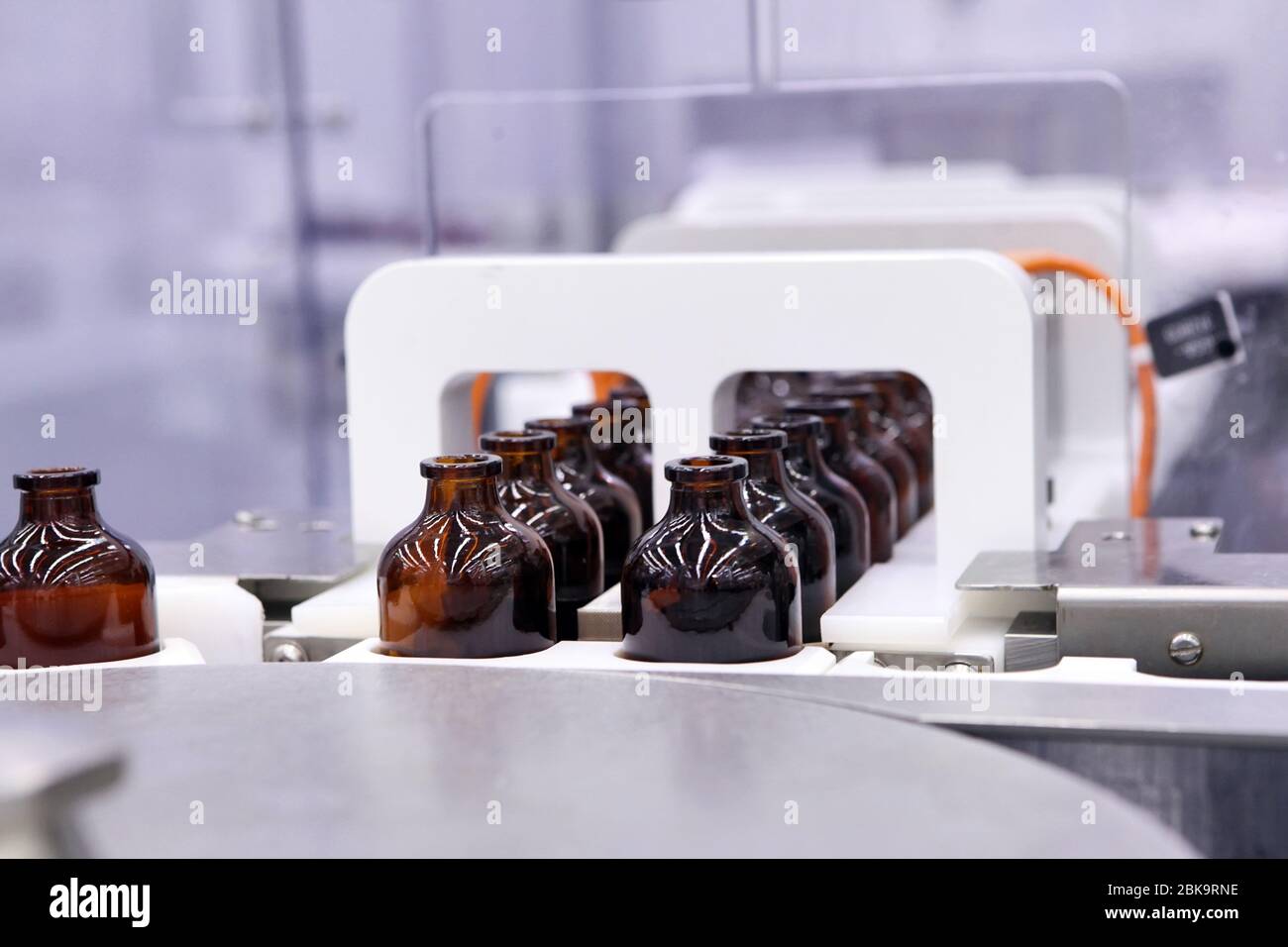 Sterile bottles and ampoules on the dispensing line. Sealed ampoules