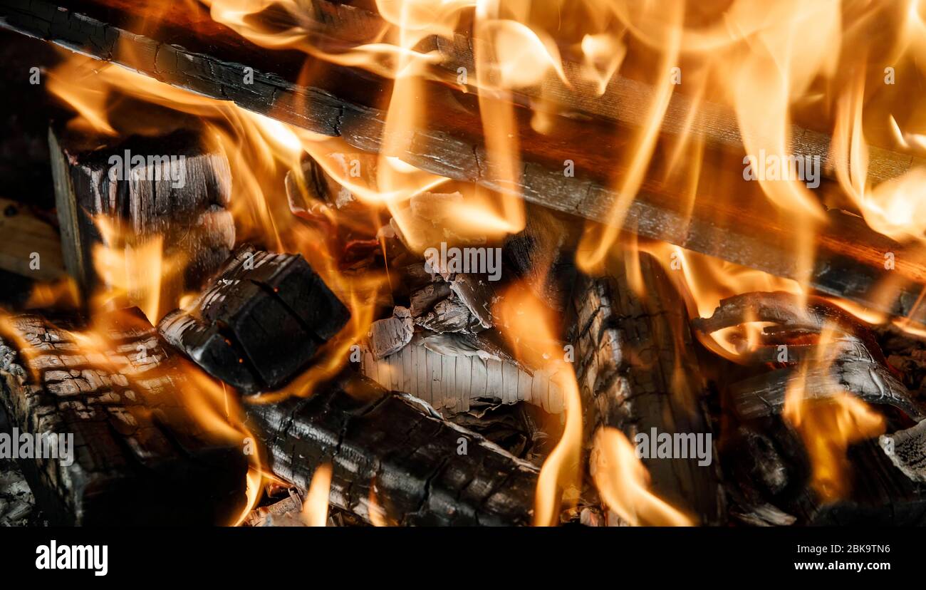 Burning coals fire from them in the grill Stock Photo