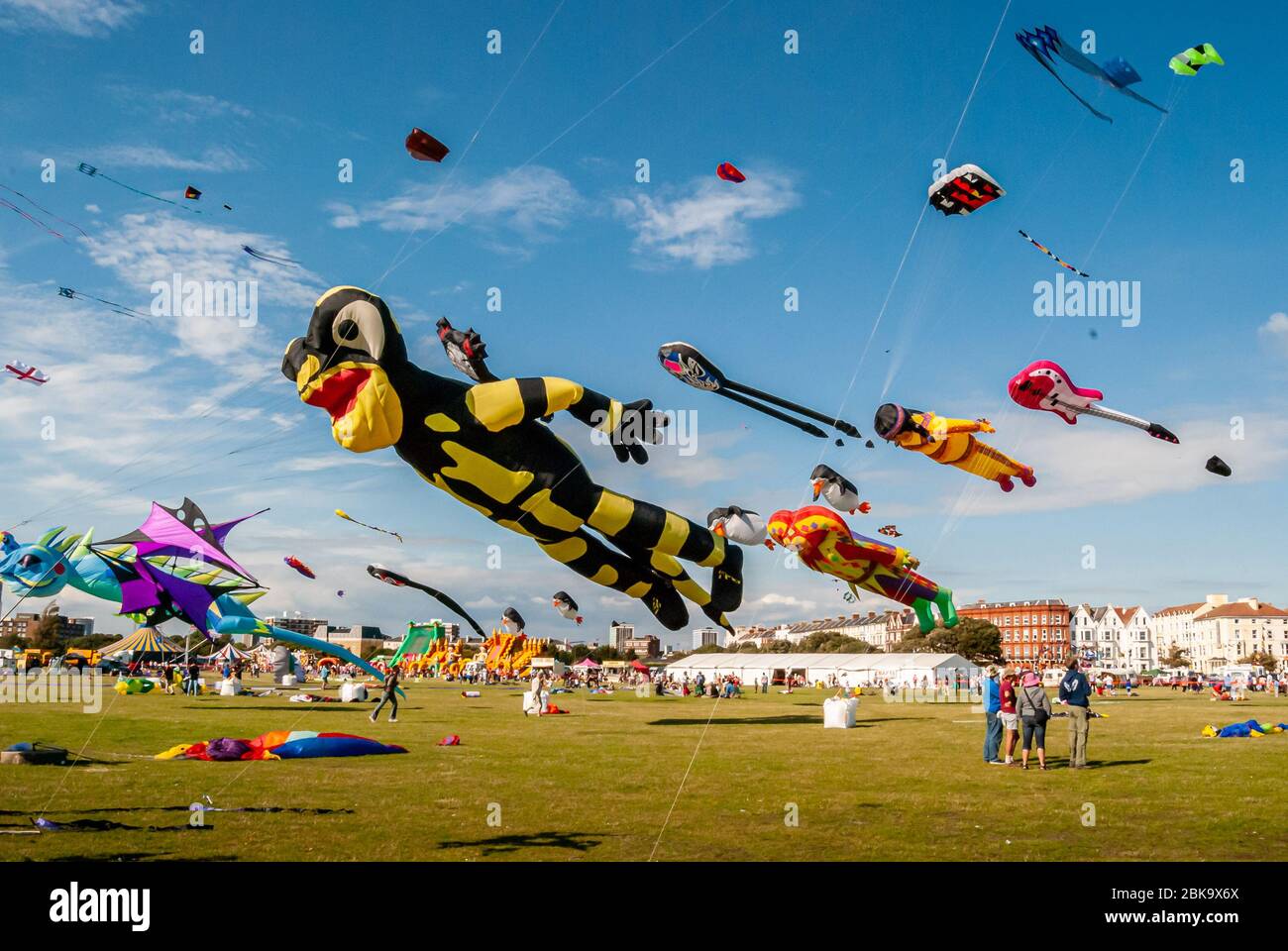 Giant, colorful flying kites fill the blue Summer sky at the Southsea Kite Festival, Portsmouth