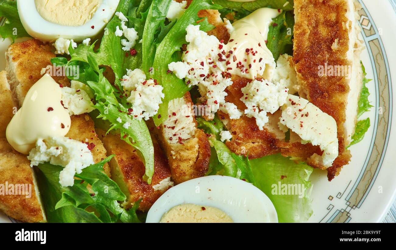 Chicken schnitzel Caesar, Crunchy, munchy schnitzel and creamy, crispy caesar salad Stock Photo