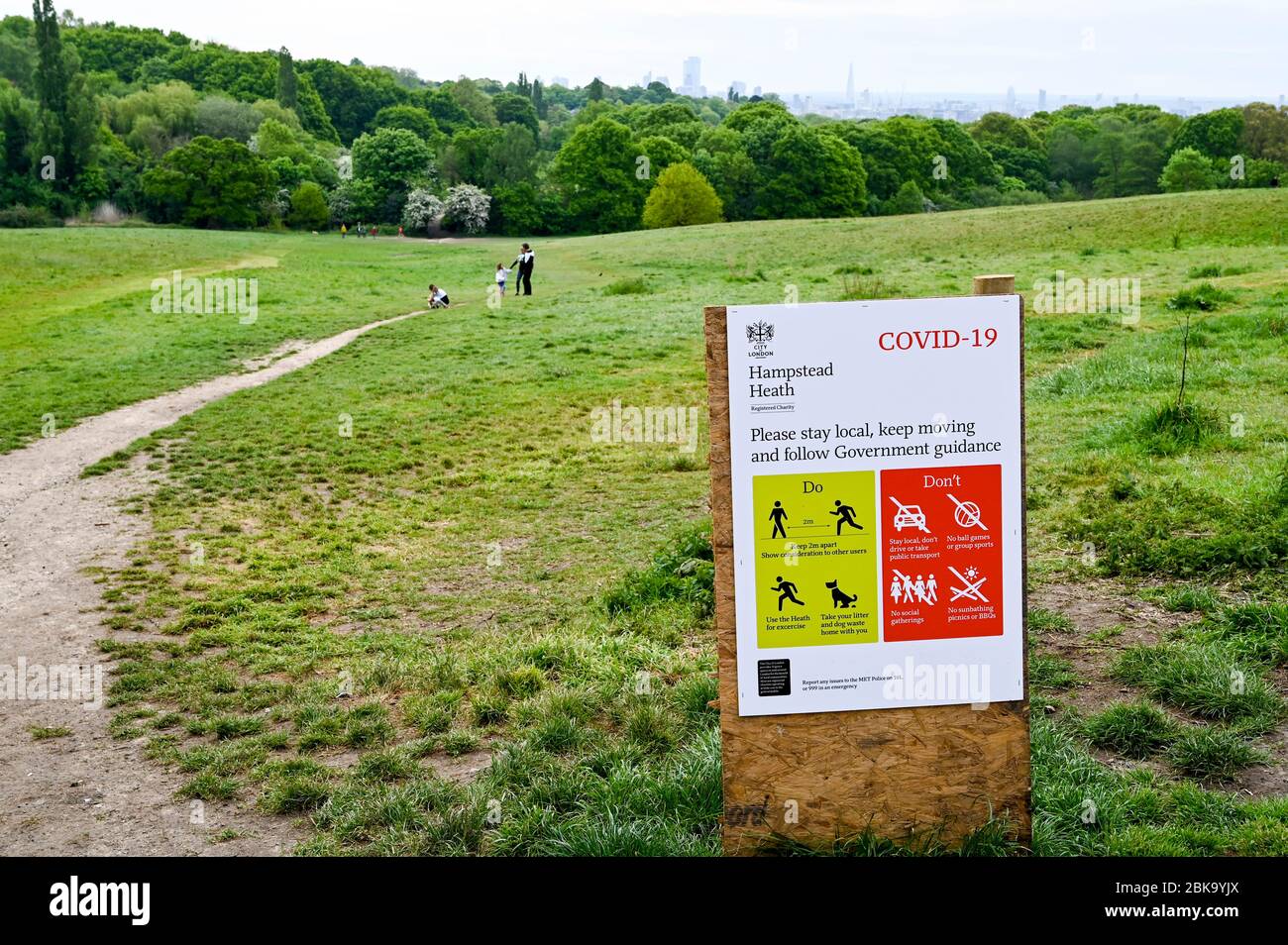 Hampstead Heath and London skyline, with illustrated instructions during the Covid-19 pandemic. People walk and run observing social distancing. Stock Photo