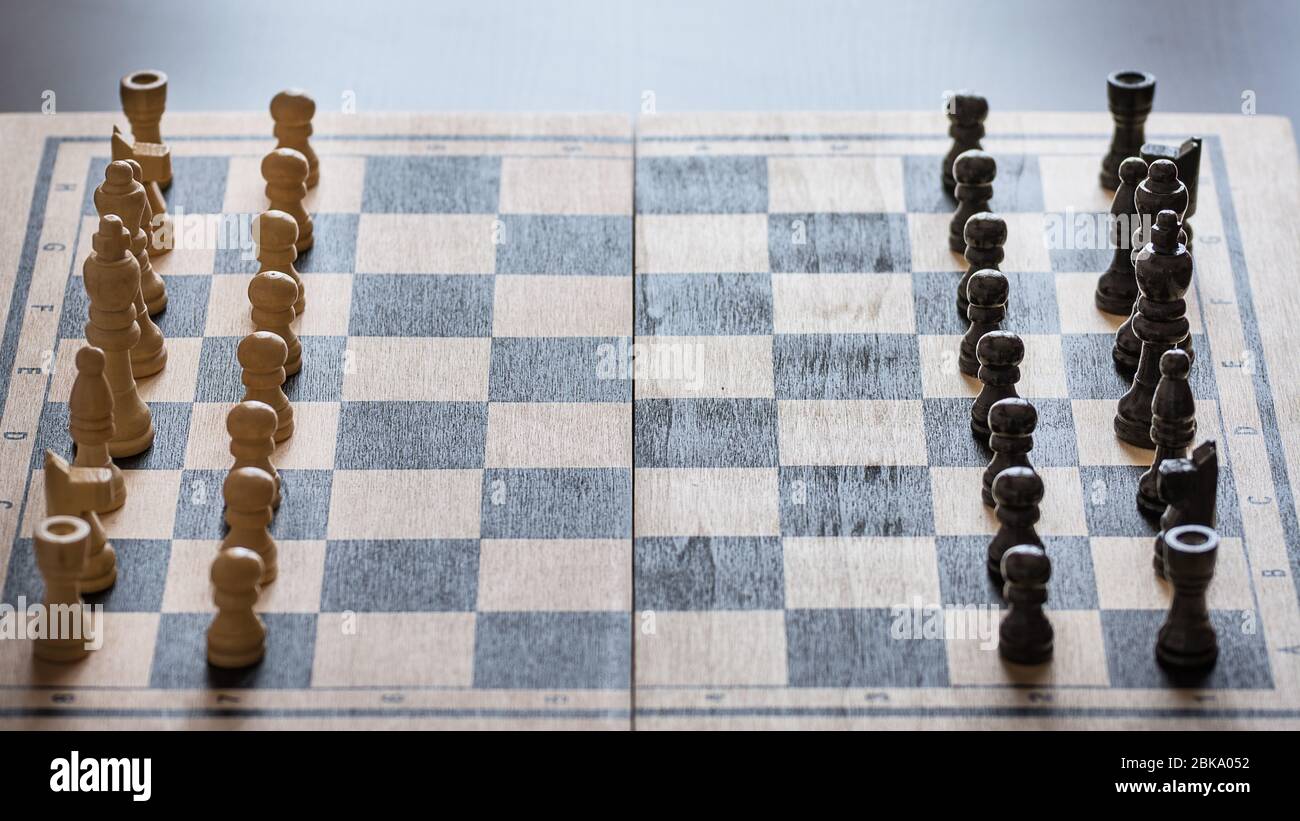 View of chess board with chess pieces on rustic wooden surface Stock Photo