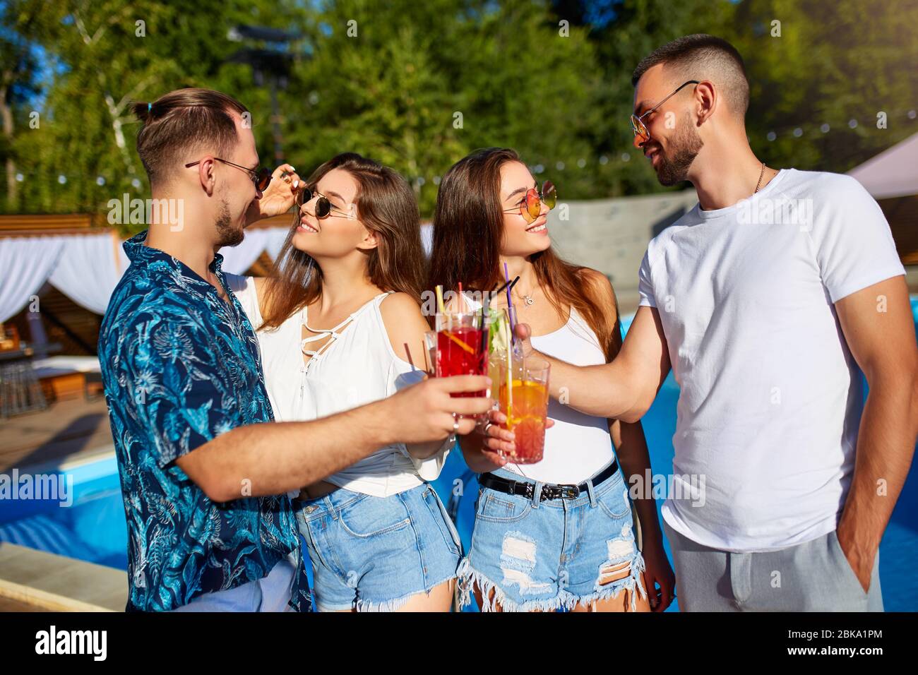 https://c8.alamy.com/comp/2BKA1PM/group-of-friends-having-fun-at-poolside-summer-party-clinking-glasses-with-summer-cocktails-on-sunny-day-near-swimming-pool-people-toast-drinking-2BKA1PM.jpg