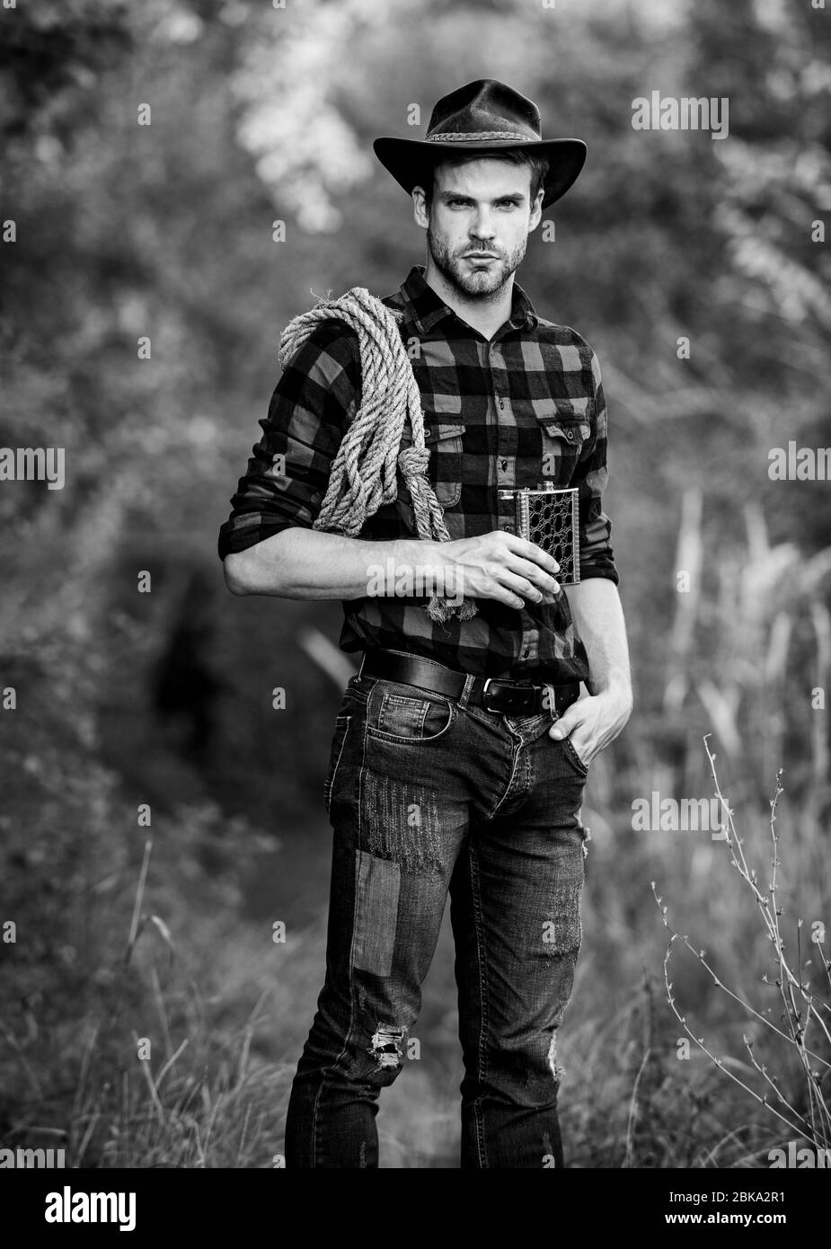 Confident Horsemen Man In Hat Drink Whiskey Western Cowboy Outdoor Portrait Cowboy With Lasso Rope Western Man Checkered Shirt On Rodeo Ranch Vintage Style Man Wild West Retro Cowboy Stock Photo Confident Horsemen Man In Hat Drink Whiskey Western Cowboy Outdoor Portrait Cowboy With Lasso Rope Western Man Checkered Shirt On Rodeo Ranch Vintage Style Man Wild West Retro Cowboy Stock Photo