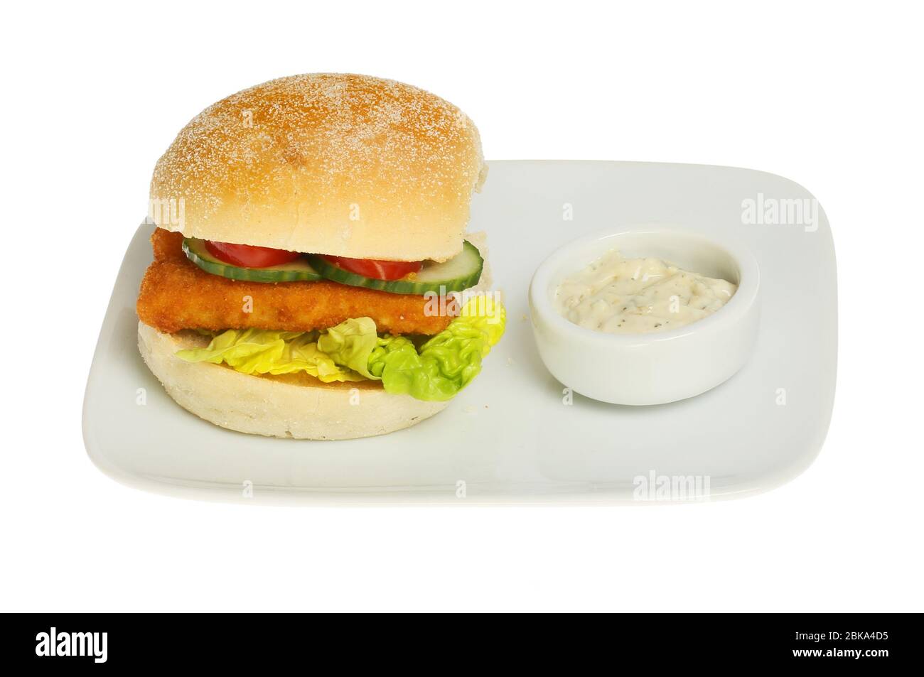 Fish fingers and salad in a roll with tartar sauce on a plate isolated against white Stock Photo